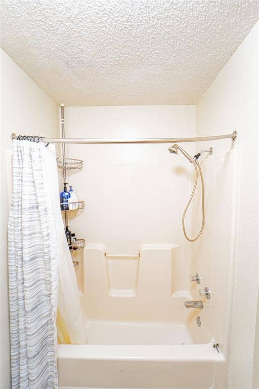 Bathtub-shower combination with a textured ceiling