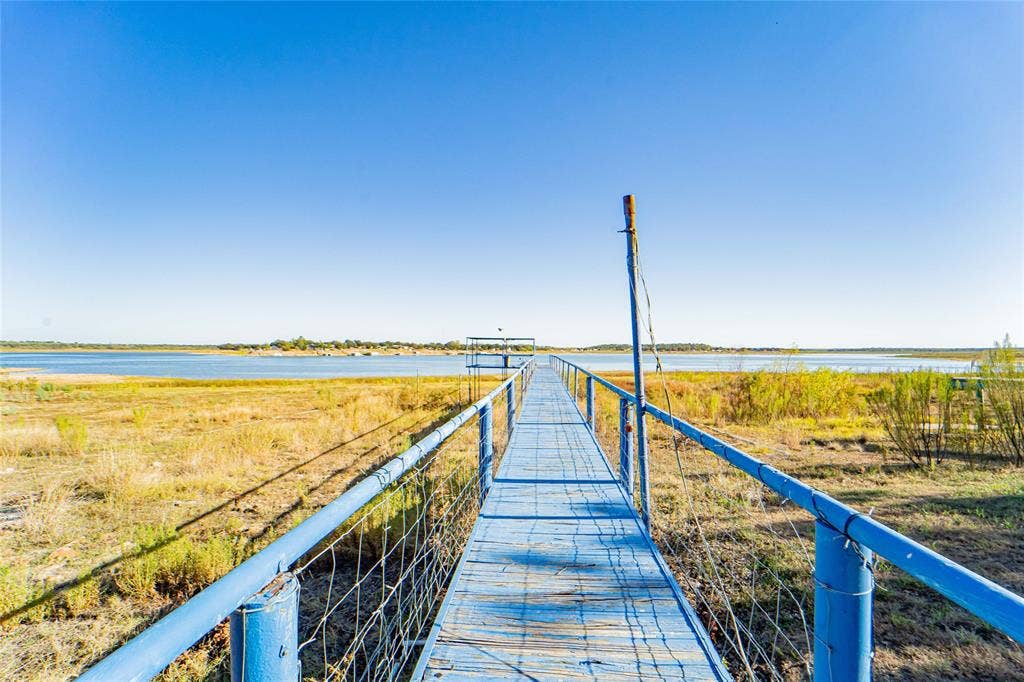 Expansive waterfront with a blue dock extending into the water