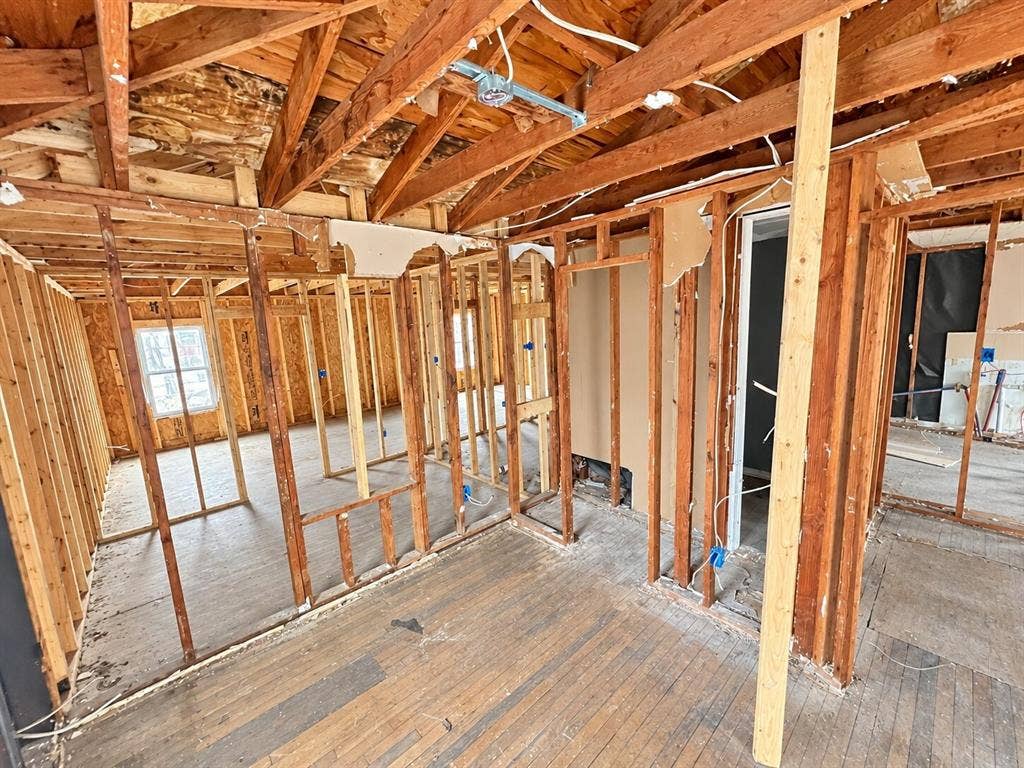 4604 Avenue H, Fort Worth, TX 76105 Exposed wood framing and ceiling rafters with partial subflooring and wood-finish flooring