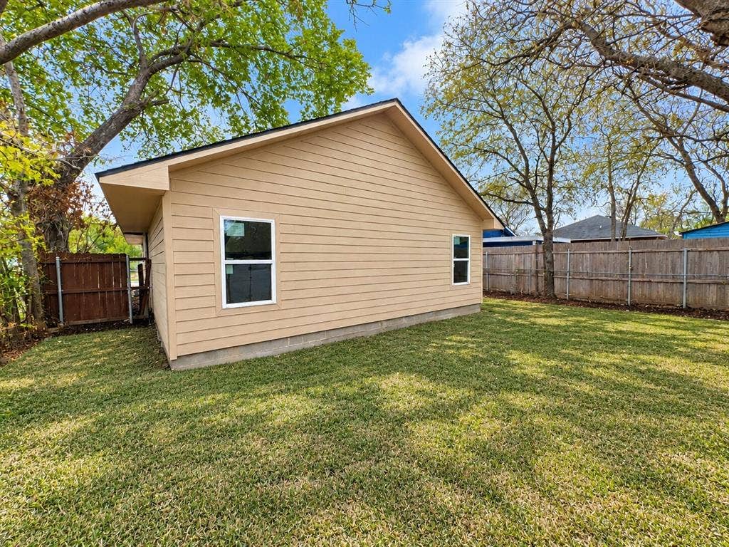 4604 Avenue H, Fort Worth, TX 76105 Exterior siding, white-trimmed windows, and a black shingle roof