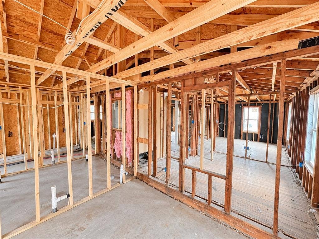 4604 Avenue H, Fort Worth, TX 76105 Exposed wood framing, vaulted ceiling structure, visible plumbing rough-ins, and unfinished window openings