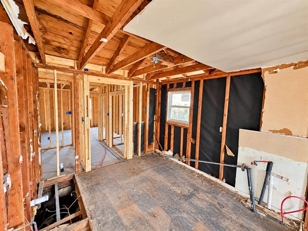 4604 Avenue H, Fort Worth, TX 76105 Exposed wood framing, visible ceiling joists, and a single-pane window