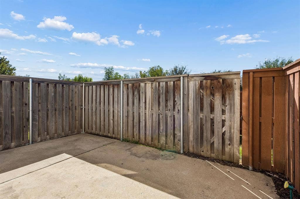 706 S Jupiter Road, #307, Allen, TX 75002 Concrete patio with privacy fencing and a dedicated gate