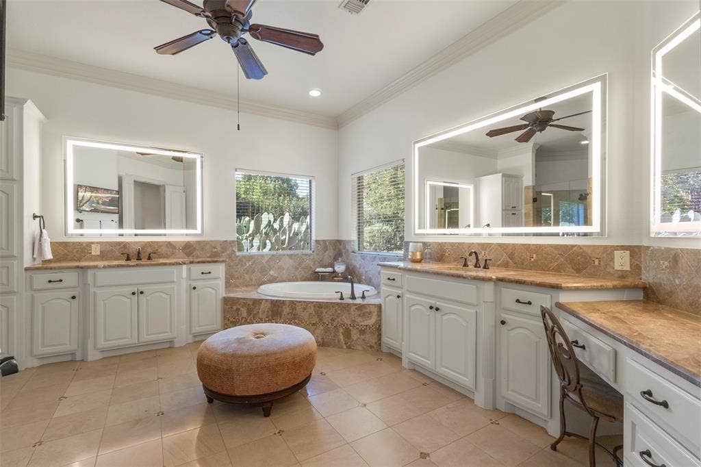15600 Big Horn Trail, Frisco, TX 75035 Dual vanities with integrated lighting mirrors, built-in soaking tub, tile flooring, and a dedicated vanity area