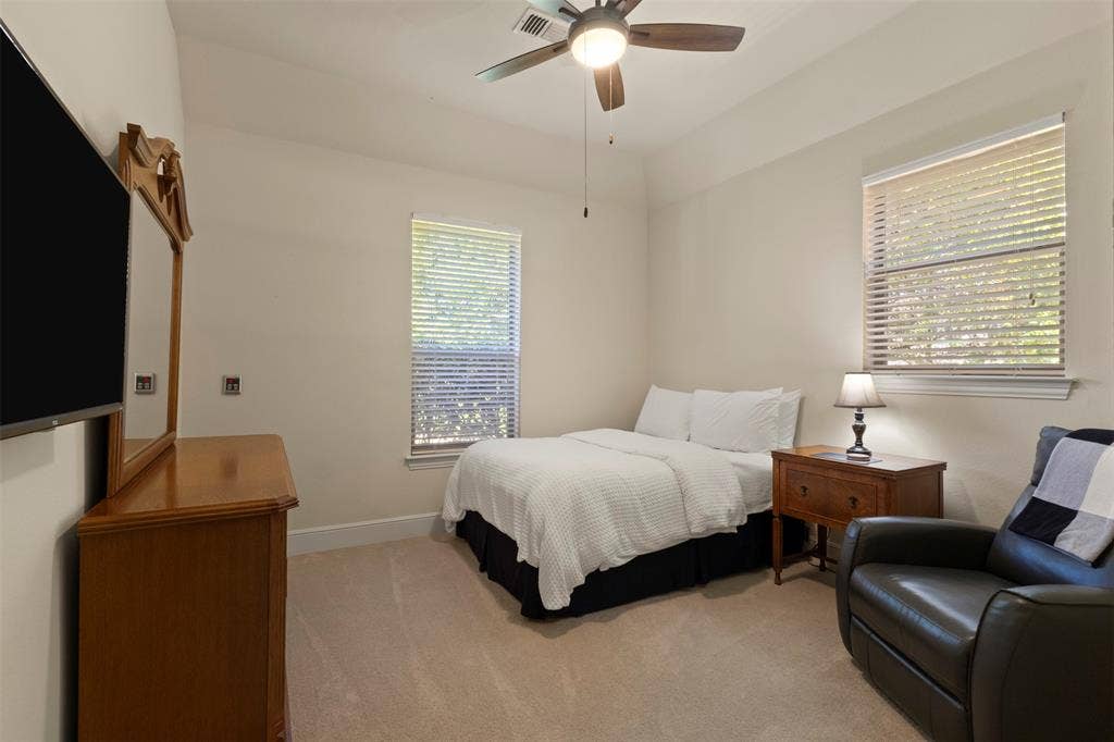 15600 Big Horn Trail, Frisco, TX 75035 Neutral wall paint, carpet flooring, a ceiling fan with integrated lighting, and a window with blinds