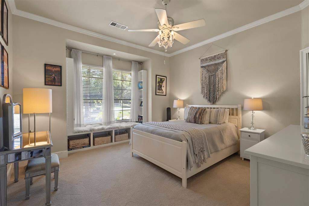 15600 Big Horn Trail, Frisco, TX 75035 Recessed window bay with built-in storage, crown molding, ceiling fan with chandelier lighting, and neutral wall tones