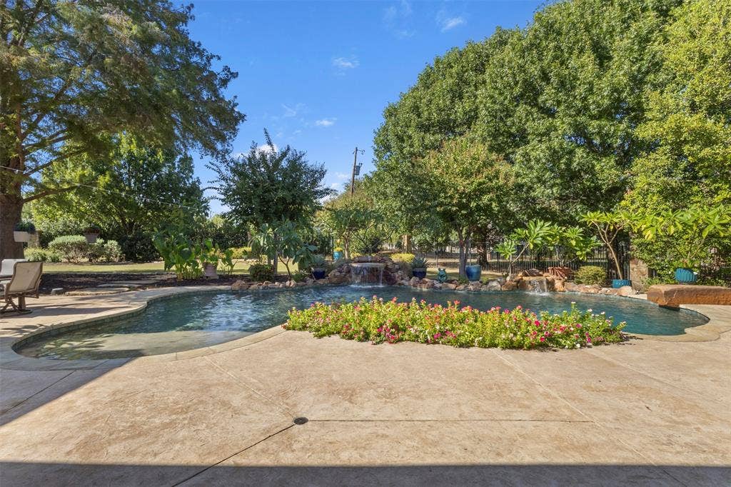 15600 Big Horn Trail, Frisco, TX 75035 Custom-shaped pool featuring a waterfall and surrounding hardscaping
