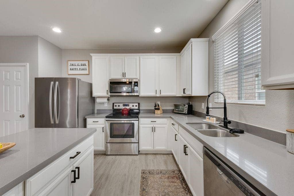 313 Citrus Drive, Fate, TX 75189 updated quartz countertops, kitchen faucet, and hardware