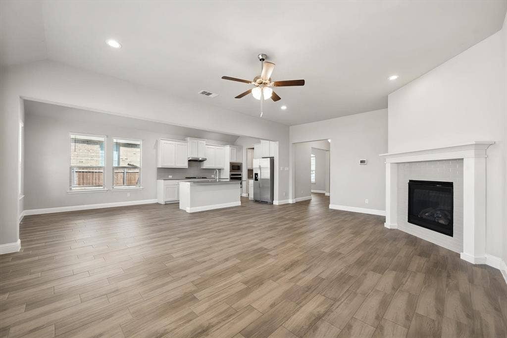 3636 Wintergreen Street, Grand Prairie, TX 76065 Open-concept living space a contemporary fireplace with tile surround, and recessed lighting