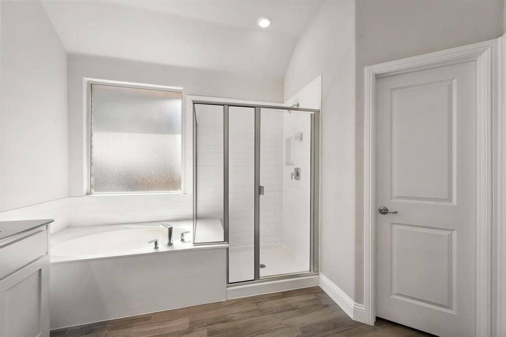 3636 Wintergreen Street, Grand Prairie, TX 76065 Soaking tub with deck-mounted fixtures, glass-enclosed shower with tile surround