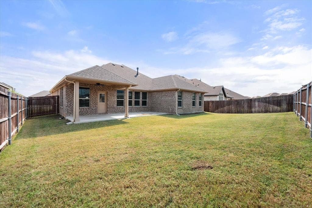 3636 Wintergreen Street, Grand Prairie, TX 76065 Expansive backyard with a covered patio and homeowner extende