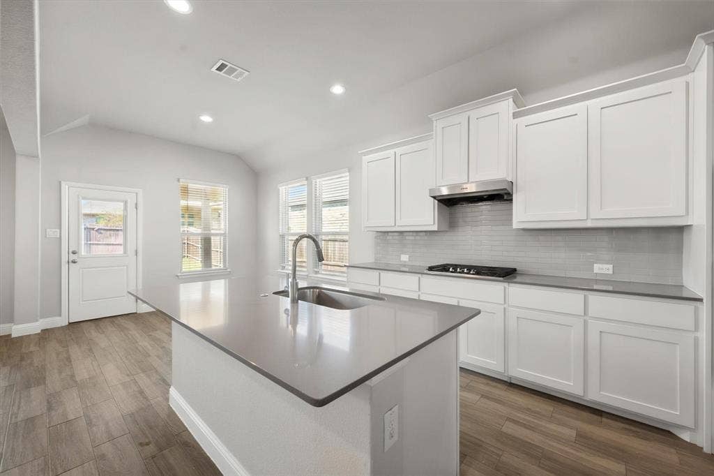 3636 Wintergreen Street, Grand Prairie, TX 76065 Kitchen featuring white cabinetry, grey countertops, stainless steel range hood and recessed lighting