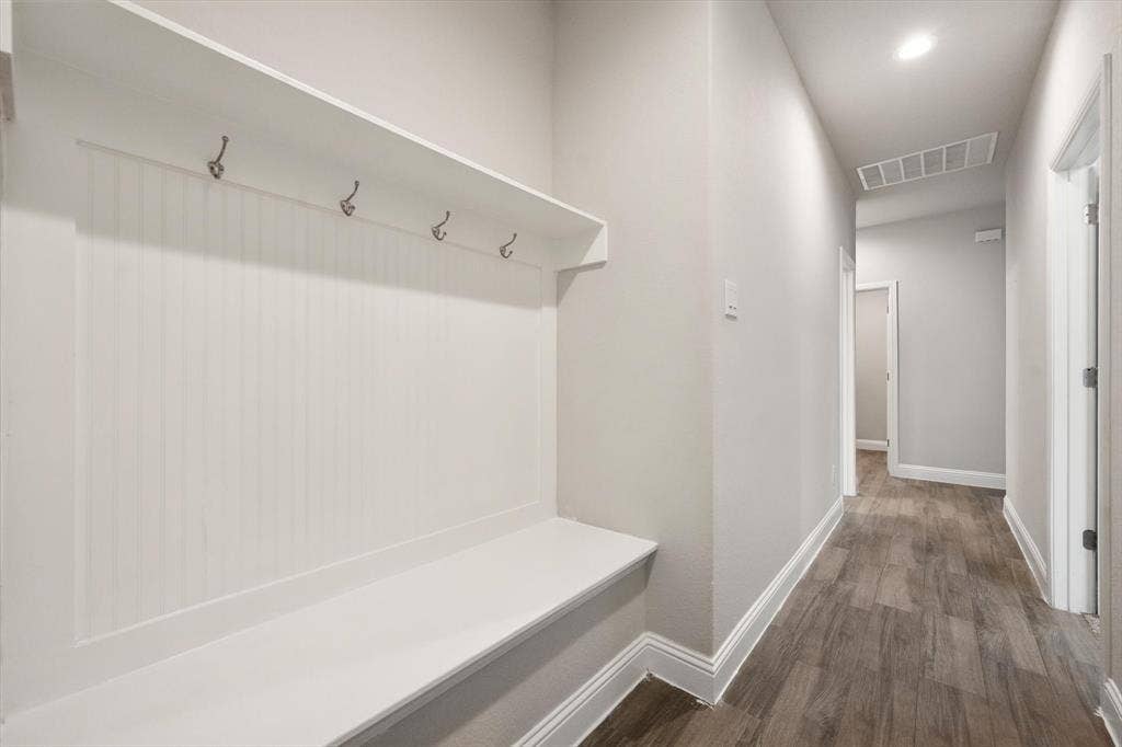 3636 Wintergreen Street, Grand Prairie, TX 76065 Built-in hall tree with bench and storage shelf, featuring metal hooks and beadboard detailing