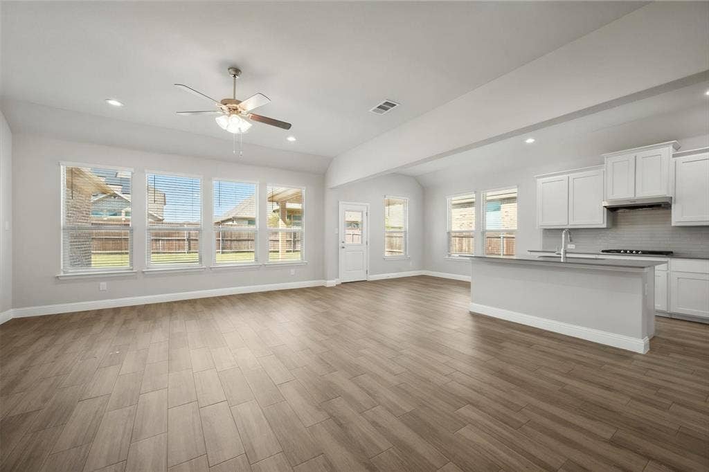 3636 Wintergreen Street, Grand Prairie, TX 76065 Open-concept living space featuring wood-finish flooring, recessed lighting, and a ceiling fan