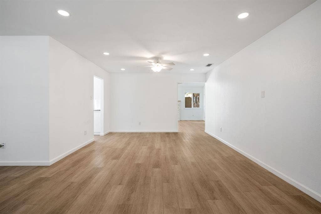 Open interior space featuring wood-finish flooring, recessed lighting, and a central ceiling fan