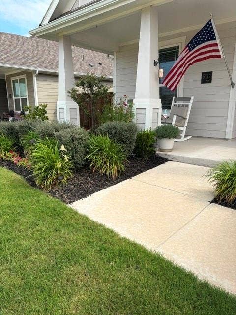5719 Huffines Boulevard, Royse City, TX 75189 Covered front porch with decorative columns, well-maintained landscaping, and a concrete walkway