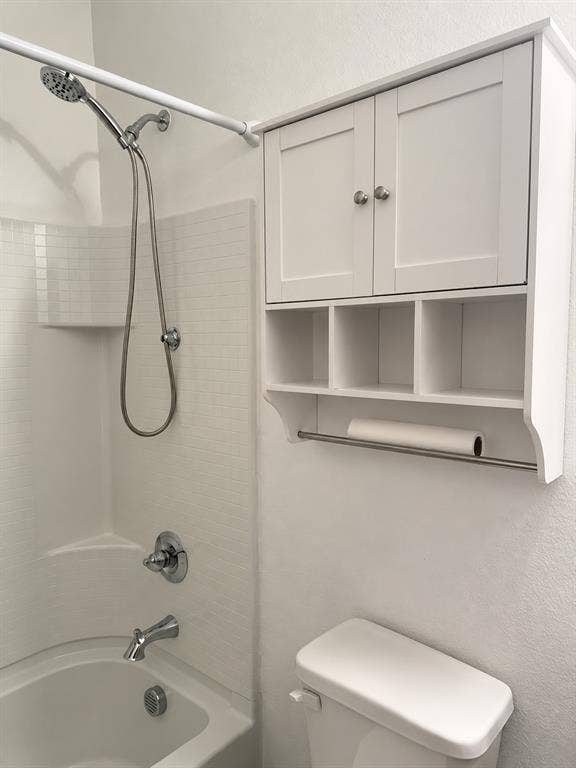 5719 Huffines Boulevard, Royse City, TX 75189 Bathtub with a handheld showerhead, chrome fixtures, and white tile surround