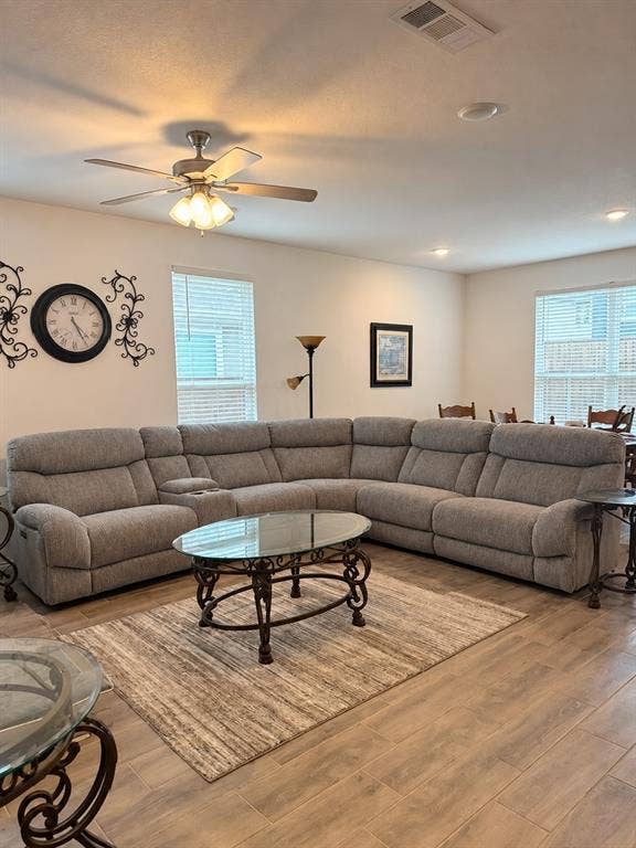 5719 Huffines Boulevard, Royse City, TX 75189 Recessed lighting, ceiling fan with light fixture, multiple windows with blinds, and wood-finish flooring throughout