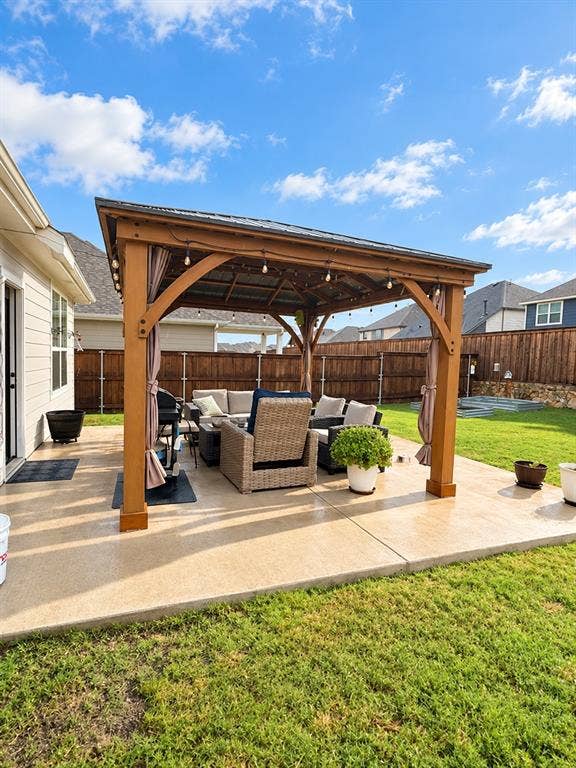 5719 Huffines Boulevard, Royse City, TX 75189 Expansive concrete patio featuring a wood-frame pergola with a metal roof