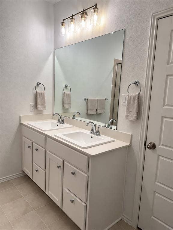 5719 Huffines Boulevard, Royse City, TX 75189 Dual vanity with undermount sinks, chrome faucets, and a full-width mirror