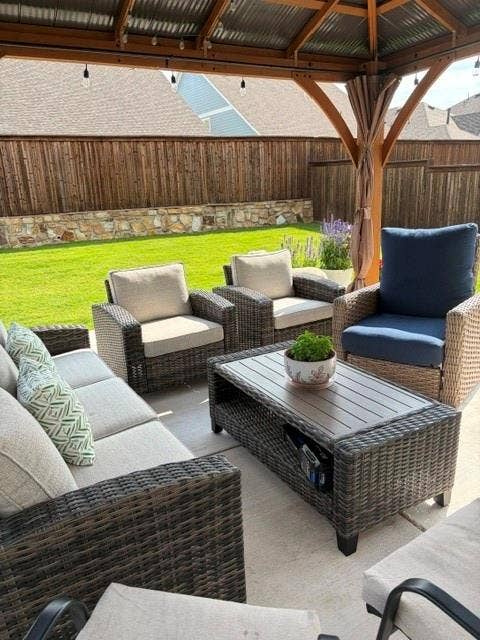 5719 Huffines Boulevard, Royse City, TX 75189 Covered patio featuring a corrugated metal roof, string lighting, and wood posts