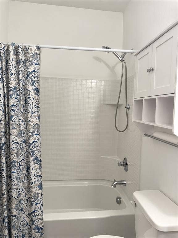 5719 Huffines Boulevard, Royse City, TX 75189 Bathtub with a tiled surround, chrome fixtures, and a multi-function showerhead