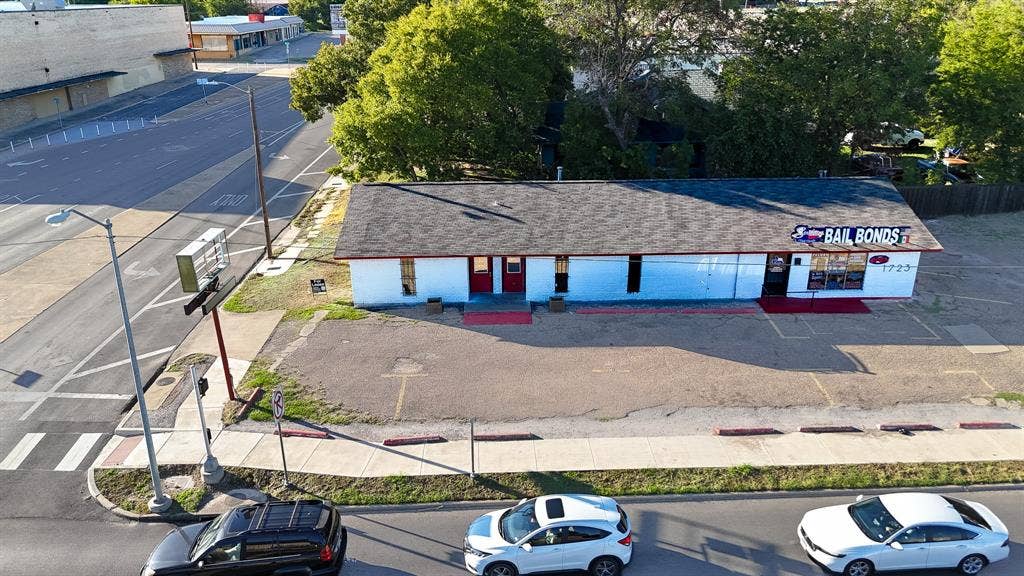 1723 W Waco Drive, #1725, Waco, TX 76707 Commercial building with a dark shingle roof and white exterior facade
