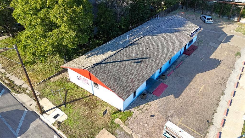 1723 W Waco Drive, #1725, Waco, TX 76707 Long-span building with a shingle roof, a red fascia, and multiple windows