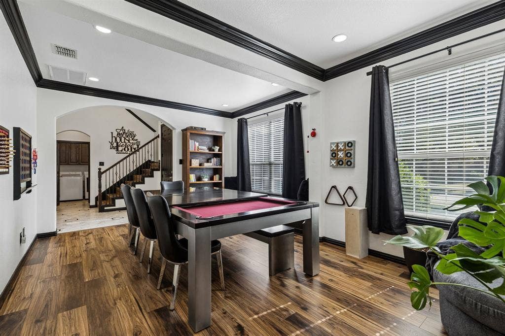 Designed with Flexibility in Mind – A wide opening connects the two front living spaces, creating an adaptable floor plan with easy access to the entry and staircase. Fresh paint, updated flooring, and contrasting black trim give the rooms a distinctive look.