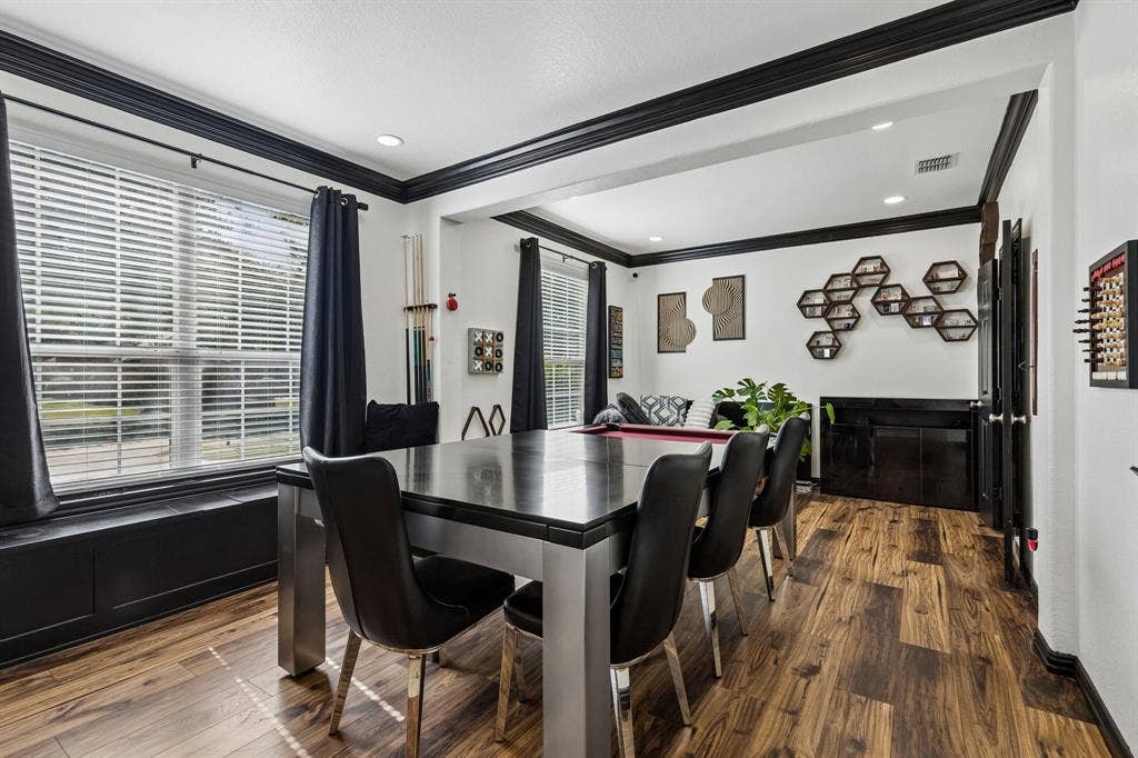Flexible Living Spaces for Your Lifestyle – Originally designed as formal living and dining rooms, these connected spaces currently serve as a spacious game room. Waterproof laminate flooring, large front-facing windows, and a built-in window seat with storage add versatility and function.