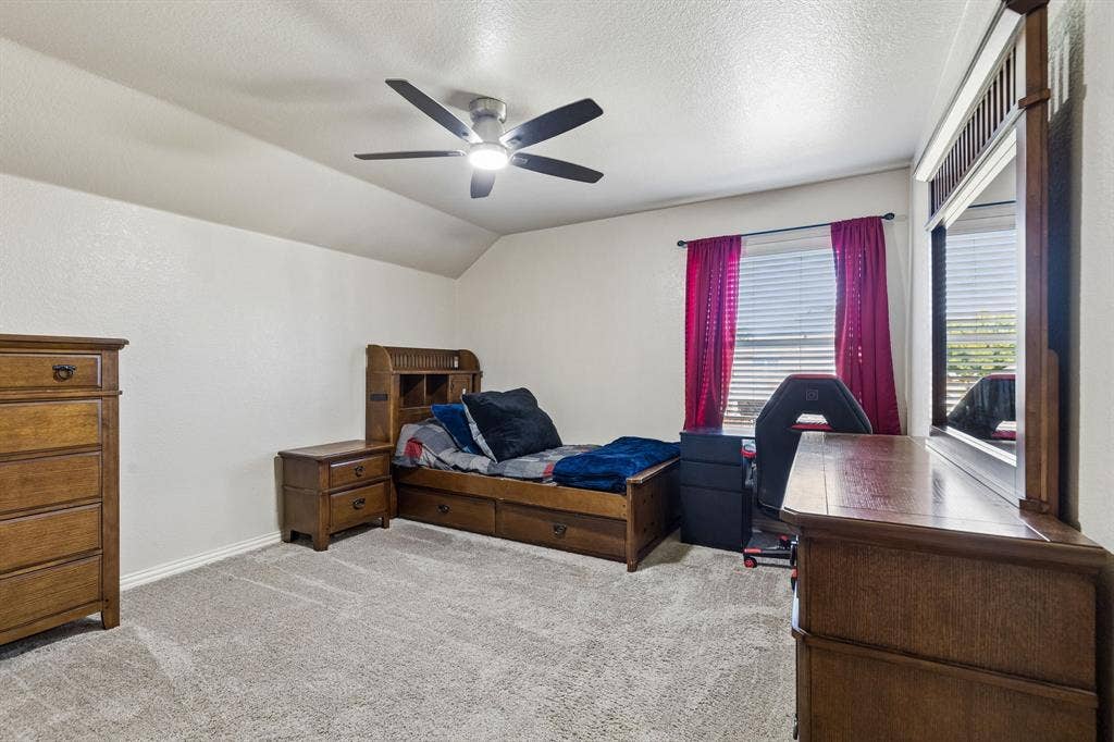Bright and Spacious Upstairs Retreat – A large window brings natural light into this generously proportioned bedroom, while the updated ceiling fan and distinctive ceiling lines add character. The room offers plenty of flexibility for sleeping, studying, or relaxing.