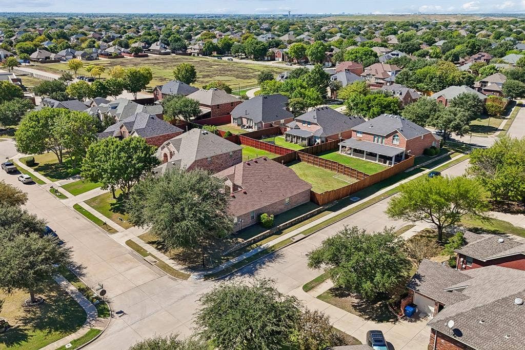 A Great Setting in Waterview – This aerial view highlights the home's desirable interior corner-lot location within an established neighborhood of attractive brick homes, mature trees, and sidewalks. Liberty Grove Elementary is just five houses away, with a pedestrian walkway at the end of the cul-de-sac.