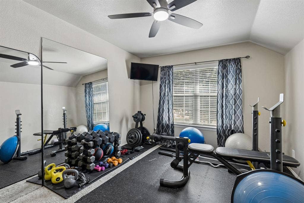 Flexible Space with Architectural Character – This upstairs bedroom features an interesting sloped ceiling, comfortable carpeting, and an updated ceiling fan with lighting. Its practical layout allows for a variety of bedroom or workspace configurations.