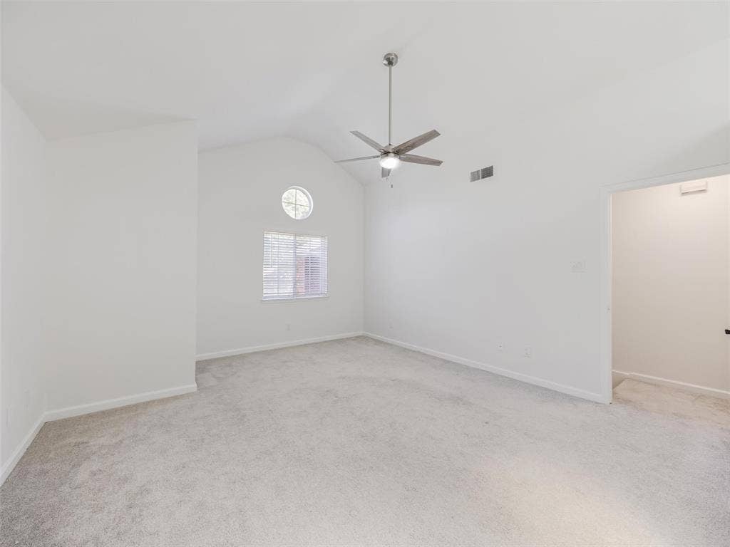 2327 N Ridge Road, McKinney, TX 75072 Vaulted ceiling featuring a ceiling fan, light gray carpet, and two windows with blinds