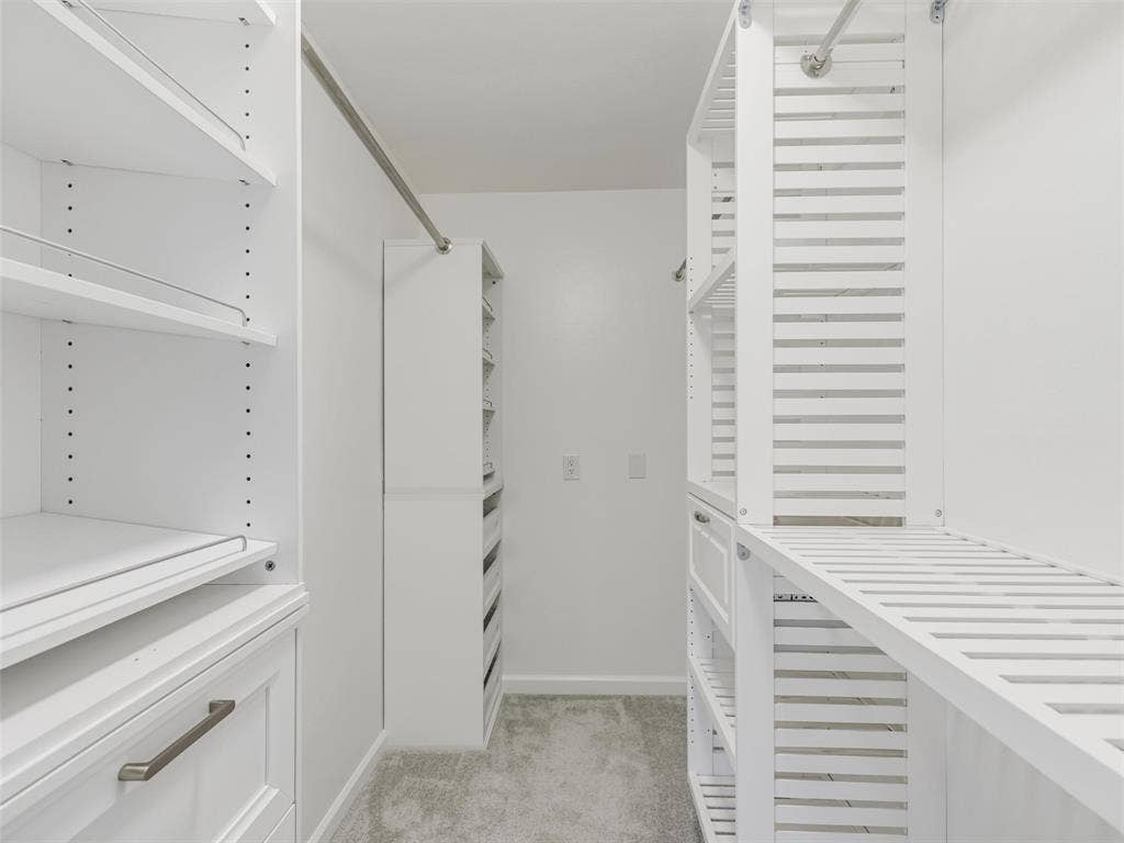 2327 N Ridge Road, McKinney, TX 75072 Custom closet system featuring white shelving and drawers with brushed nickel hardware
