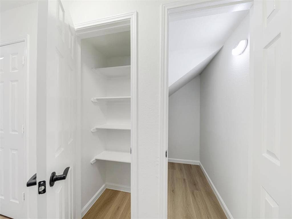 2327 N Ridge Road, McKinney, TX 75072 Built-in shelving, wood-finish flooring, interior lighting, and white paneled doors