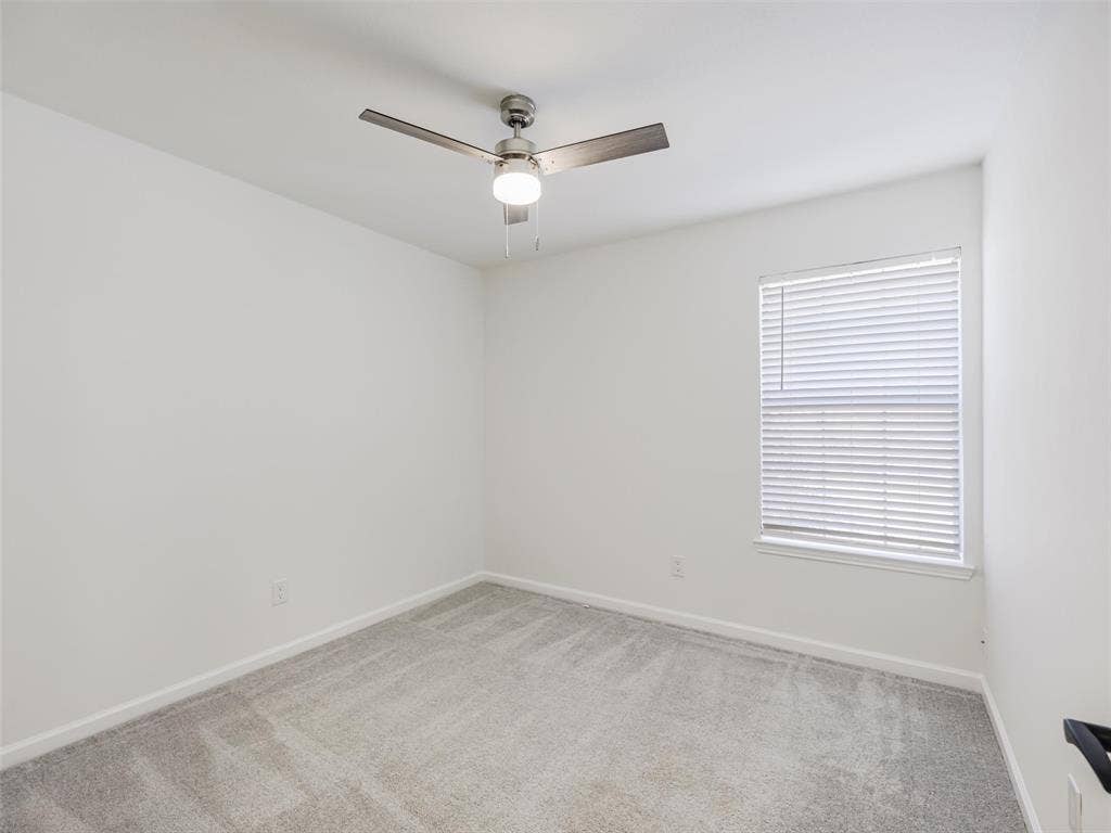2327 N Ridge Road, McKinney, TX 75072 Neutral wall paint, ceiling fan with integrated lighting, window with blinds, and carpeted flooring