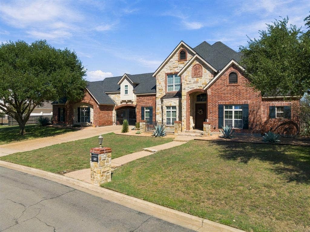 1021 Cascade Trail, McGregor, TX 76657 Brick and stone facade with arched entryways