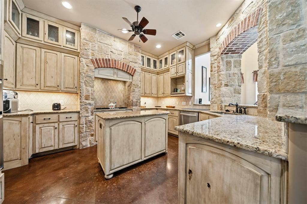 1021 Cascade Trail, McGregor, TX 76657 Stone accent walls with brick archways