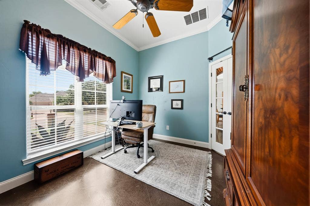 1021 Cascade Trail, McGregor, TX 76657 Vaulted ceiling with a ceiling fan, French doors, and large windows with blinds