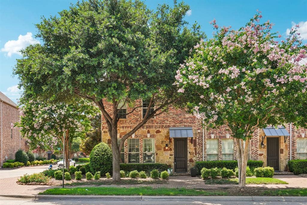 7937 Parkwood Boulevard, Plano, TX 75024 Brick and stone facade with decorative window awnings