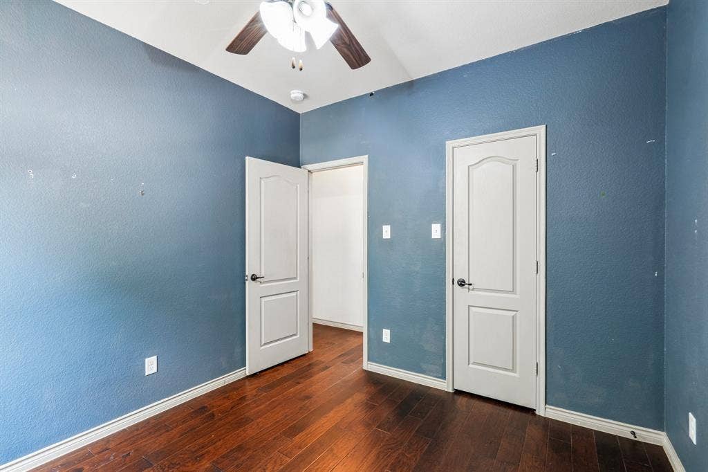 7937 Parkwood Boulevard, Plano, TX 75024 Wood-finish flooring, white panel doors, and a ceiling fan with integrated lighting