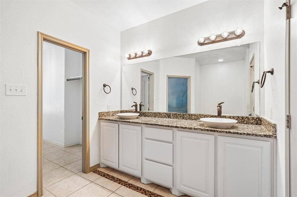 7937 Parkwood Boulevard, Plano, TX 75024 Dual vessel sinks set in a stone-finish countertop