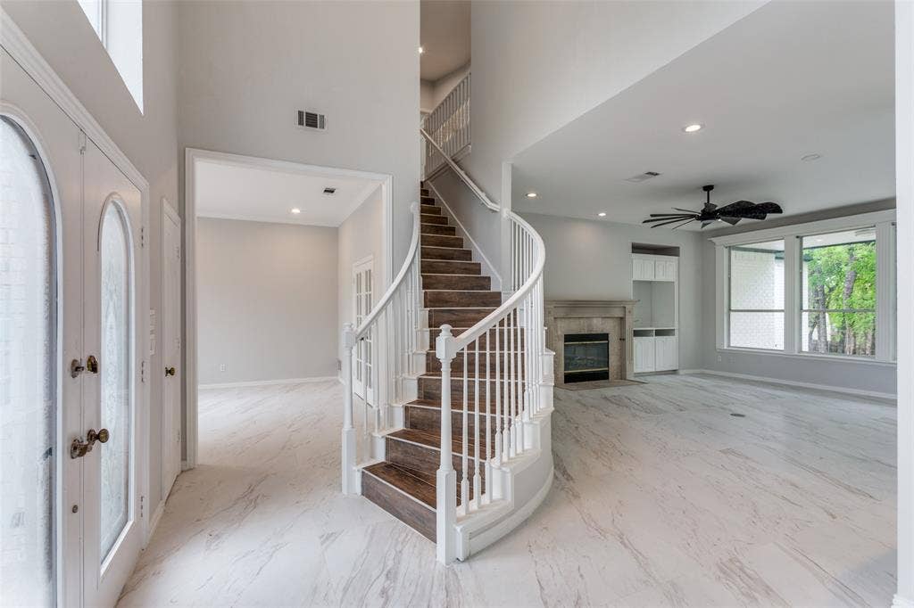 6315 Millwood Court, Arlington, TX 76016 Grand entry with a curved staircase featuring wood-finish treads and white risers