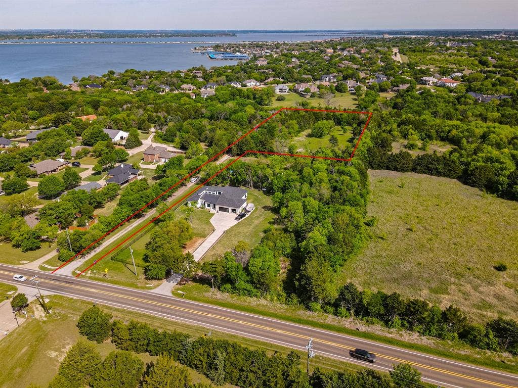 1603 Smirl Drive, Heath, TX 75032 Expansive property featuring a modern residence, dedicated driveway, and established trees