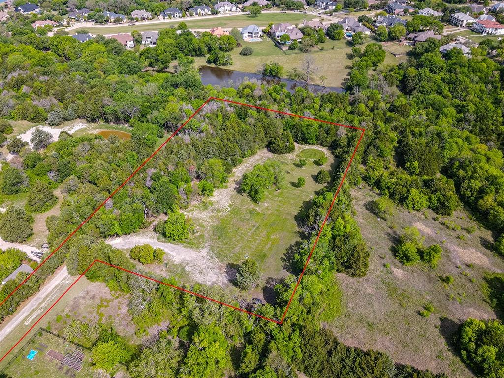 1603 Smirl Drive, Heath, TX 75032 Expansive treed lot with varied terrain, including open clearings and dense foliage