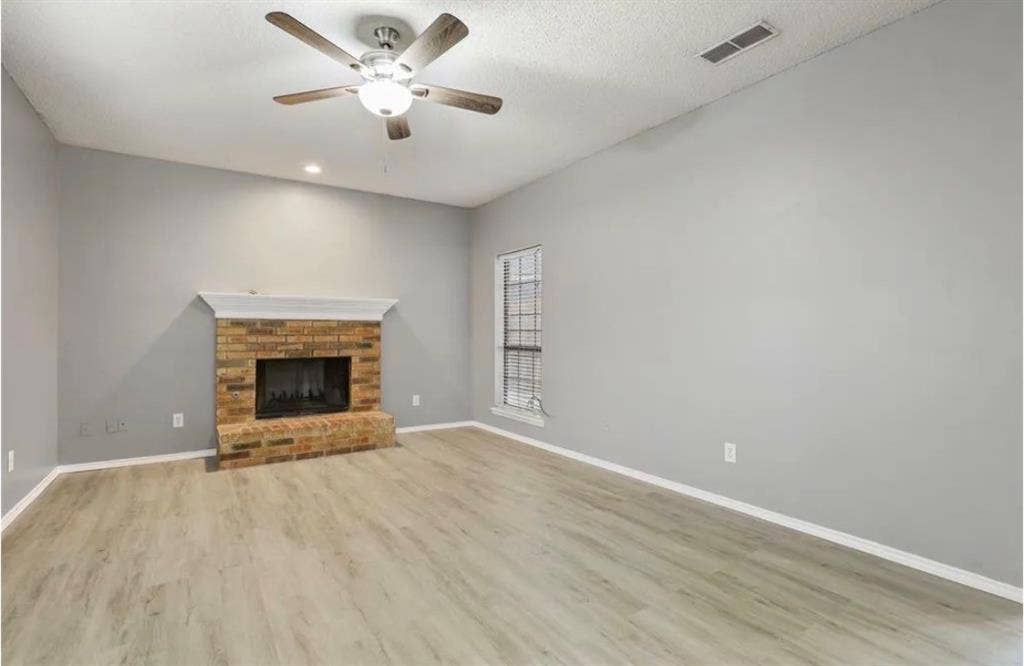 8943 Camfield Way, Frisco, TX 75033 Vaulted ceiling, brick fireplace with mantel, wood-finish flooring, recessed lighting, and ceiling fan