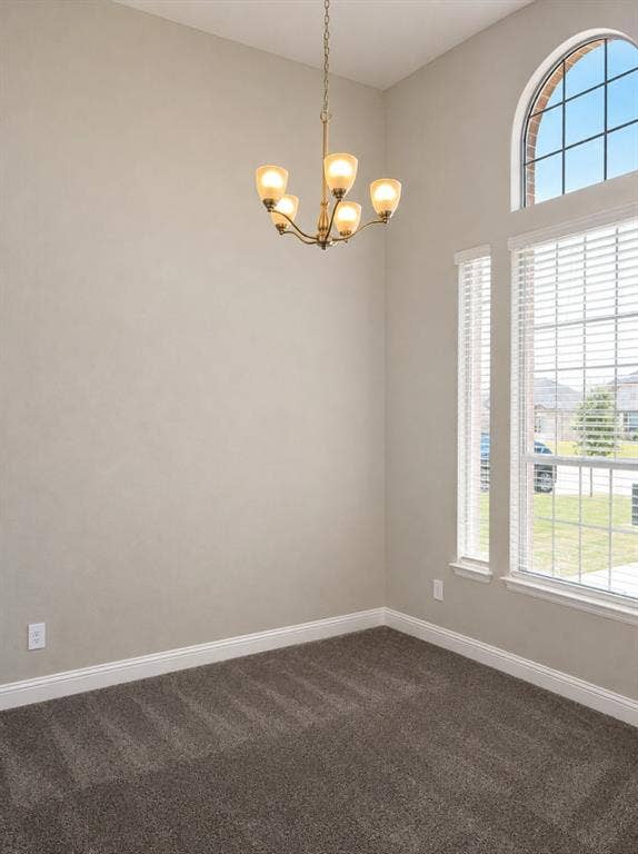 6002 14th Street, Midlothian, TX 76065 Vaulted ceiling with a five-light chandelier, arched transom window, dual pane windows, and neutral carpeting