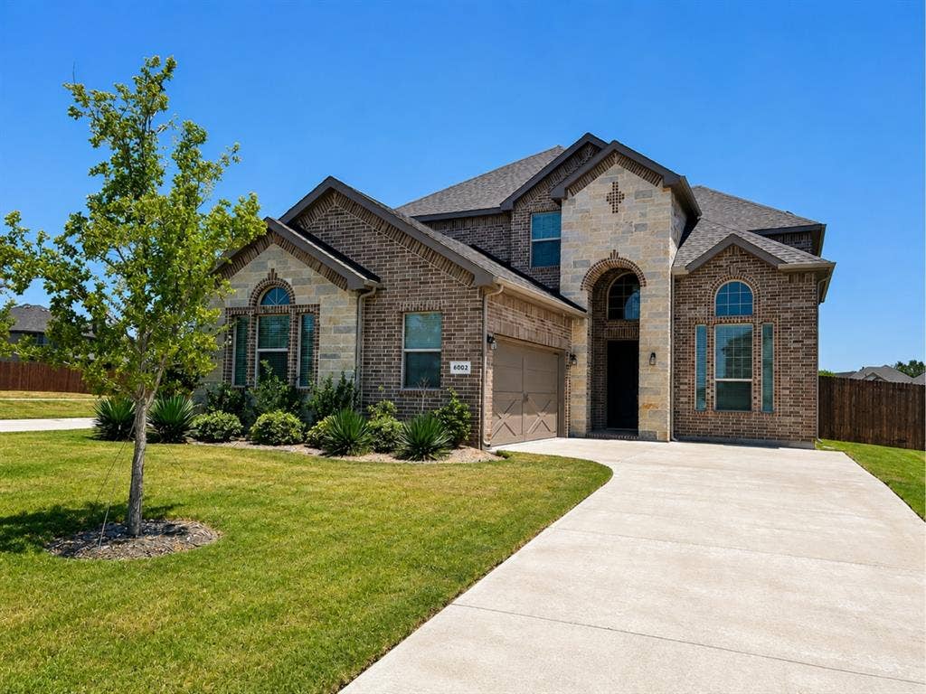 6002 14th Street, Midlothian, TX 76065 Stately brick and stone exterior with a prominent arched entry