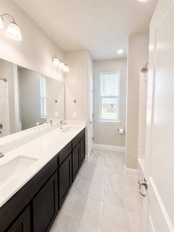 6002 14th Street, Midlothian, TX 76065 Dual vanity with integrated sinks, white countertops, and dark wood-finish cabinetry
